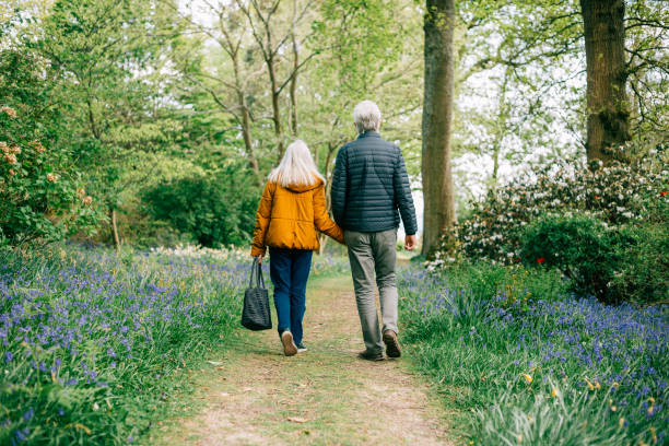 istock Senior couple walking together in nature 1407285567