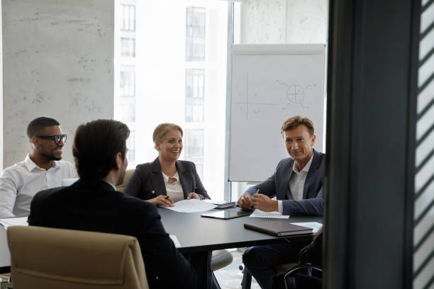 istock Young and middle-aged businesspeople take part in group meeting 1407285656