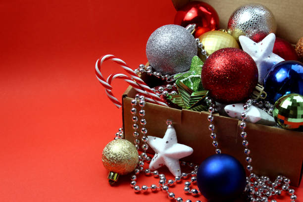 istock A box with Christmas toys stands on a red background 1407287080