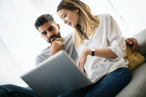 istock Young couple using a laptop at home. 1407287267