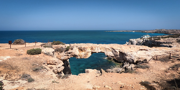Kamara Tou Koraka Stone Arch Monarchus Arch, called a Love Bridge. Cyprus, Cape Greco.