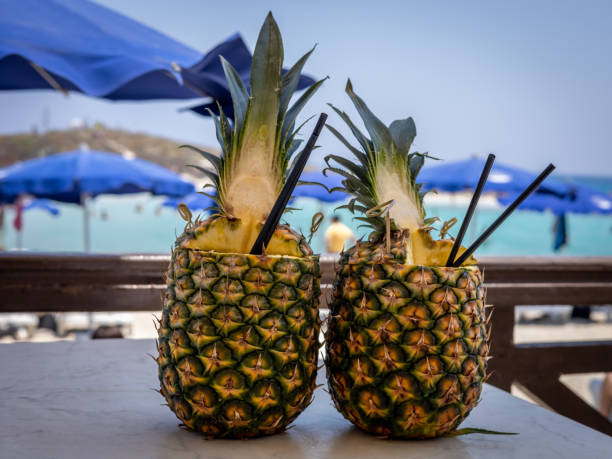 due pinacolada coctails in frutta fresca di ananas sul tavolo del bar. - umbrella two objects cocktail drink foto e immagini stock