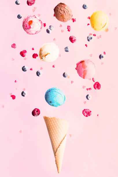 istock Falling ice cream scoops and berries into the vafel cone 1407293780