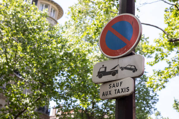 istock No parking sign on a metal post under trees in summer 1407295085