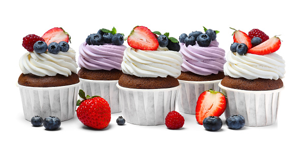 Sweet cupcakes with fresh berries on white background