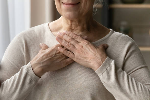 istock Older female put her hands on chest close up view 1407303670