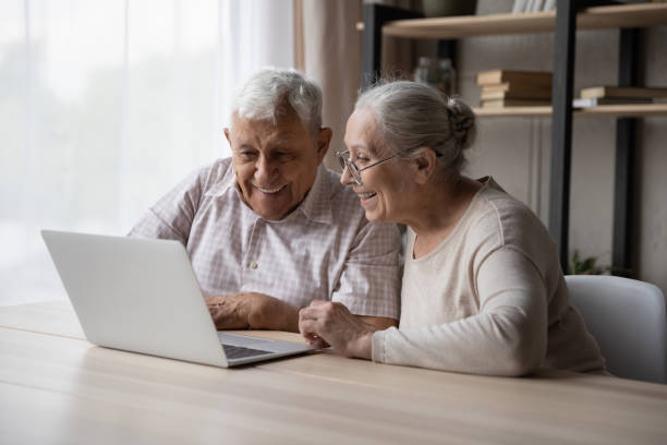 istock Happy older couple using laptop buying goods through e-commerce 1407303728