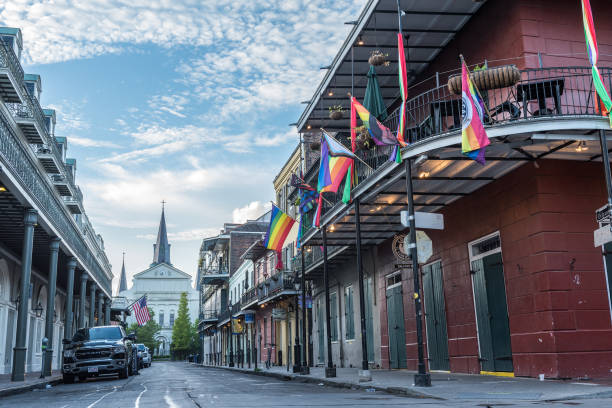 New Orleans, LA, USA - June 29, 2022: View of Bourbon Street at sunrise, without the daily activity of tourists who frequent this area for parties and fun. In the background, in the image we can see the Saint Louis Cathedral. Bourbon Street is the hub of nightlife in the French Quarter of New Orleans.