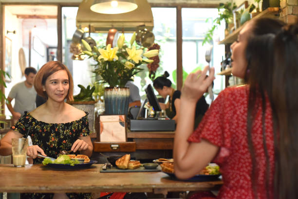 istock Young women communicate with each other in cafe 1407308482