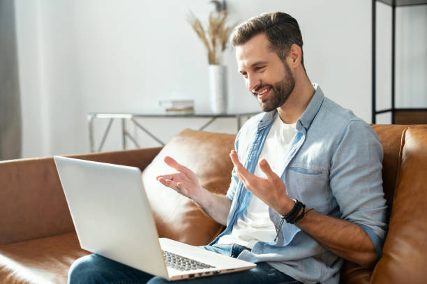 istock Young bearded hipster man with laptop on his lap 1407308815