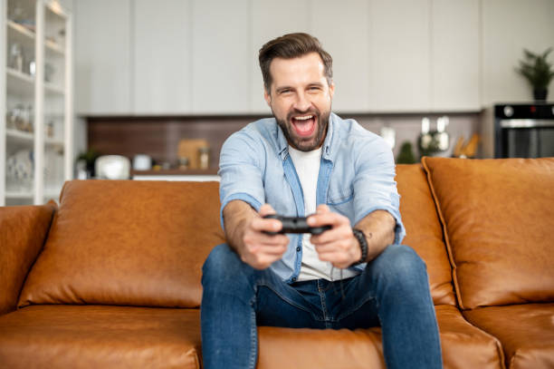 istock Young bearded hipster man playing video games 1407308820