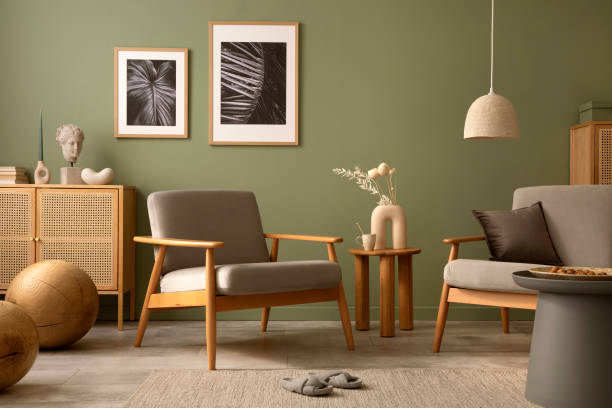istock Stylish living room interior design with armchair, modern commode, mock up frames and creative home accessories. Template. Copy space. 1407309497