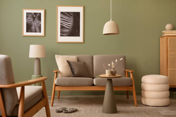 istock Elegant composition of living room interior. Modern scandi sofa, design pillows, side table, rattan commode and creative personal accessories. Sage green wall. Template. Copy space. 1407309544