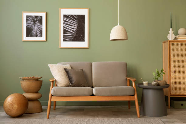 istock Stylish living room interior composition. Modern scandi sofa,  mock up frames, wooden commode and creative personal accessories. Eucalyptus green wall. Template. Copy space. 1407309564