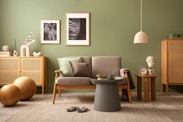 istock Stylish living room interior composition. Modern scandi sofa,  mock up frames, wooden commode and creative personal accessories. Eucalyptus green wall. Template. Copy space. 1407309640