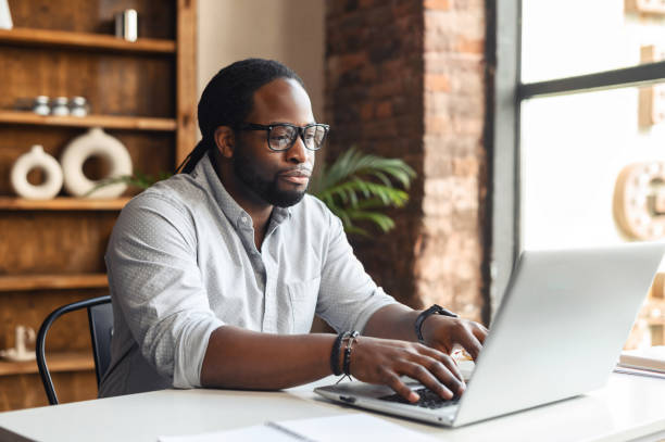 istock African-American male author typing on a laptop 1407309655