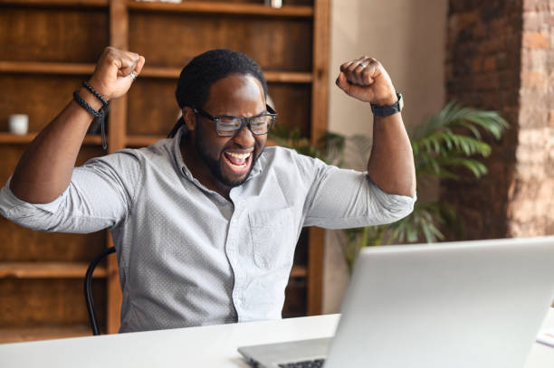 istock Lucky African American manager raised fists up 1407309675