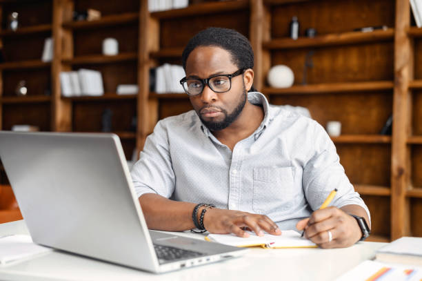 istock E-learning concept, casual african american business man writing on notebook 1407309697