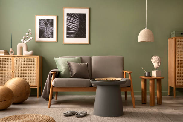 istock Elegant composition of living room interior. Modern scandi sofa, design pillows, side table, rattan commode and creative personal accessories. Sage green wall. Template. Copy space. 1407309714