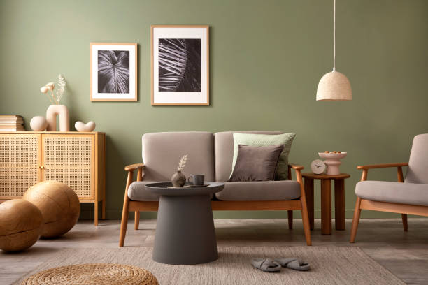 istock Elegant composition of living room interior. Modern scandi sofa, design pillows, side table, rattan commode and creative personal accessories. Sage green wall. Template. Copy space. 1407309760
