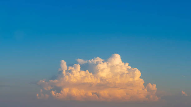 istock A big beautiful cloud in the blue sky in summer. The sky with a large beautiful single cloud. a big fluffy cloud in a clear sky 1407310551