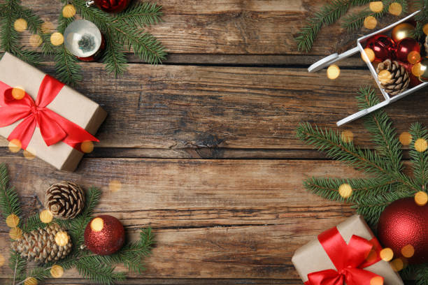 istock Christmas greeting card with space for text. Flat lay composition of fir tree branches and festive decor on wooden background 1407310932