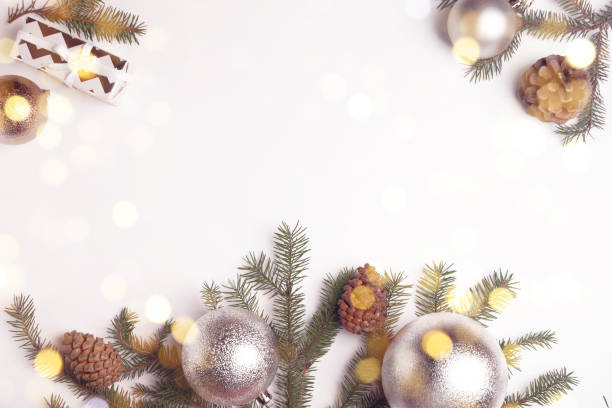 istock Christmas greeting card with space for text. Flat lay composition of fir tree branches and festive decor on white background 1407310945