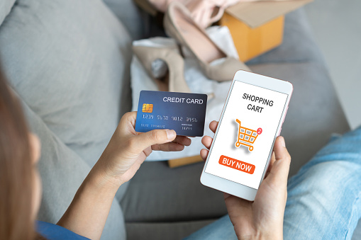 Woman hands using mobile phone for ordering fashion items on online application and pay by credit card. E commerce business and technology, Digital marketing, Online shopping concept