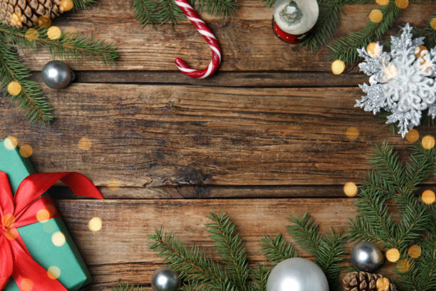 istock Christmas greeting card with space for text. Flat lay composition of fir tree branches and festive decor on wooden background 1407310950