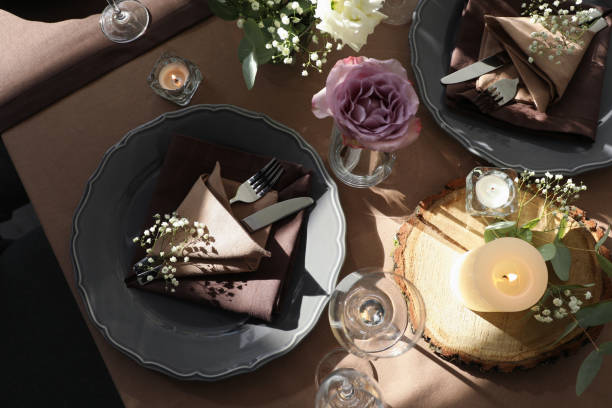 istock Festive table setting with beautiful tableware, candles and floral decor indoors, top view 1407310981