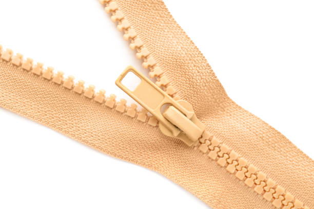 Beige zipper on white background, top view