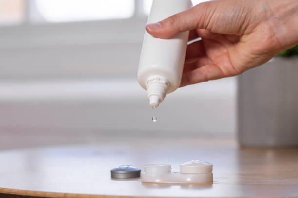 istock Saline Dropping into Contact Lens Case 1407311486