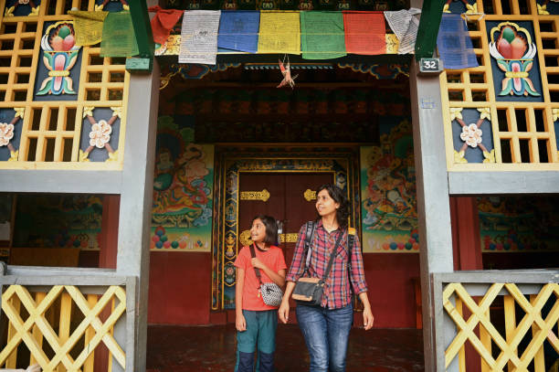 istock Mother and daughter walking in a Buddhist Monastery 1407312971