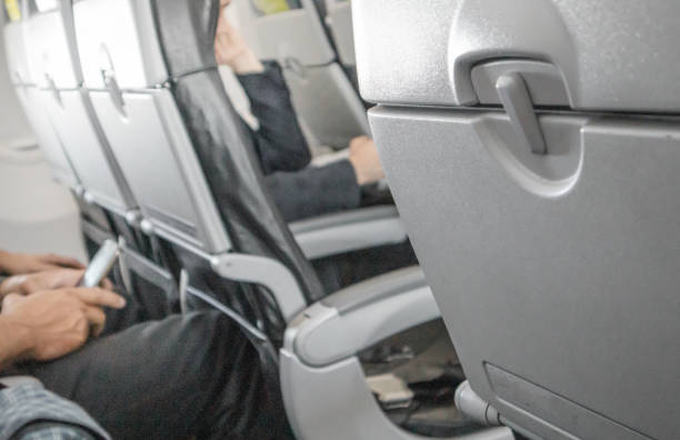 istock Selective focus on a closed table, a table for food in the cabin, a blurred background of passengers in the background of the interior, the concept of convenient flights and travel 1407312989