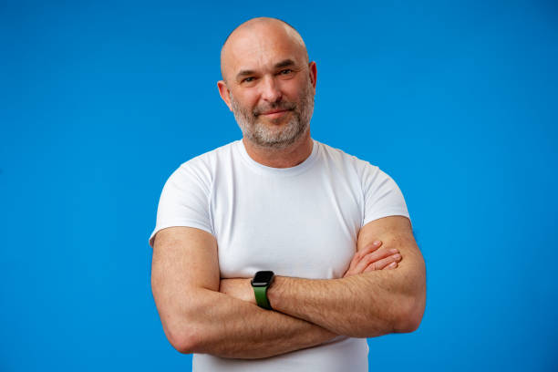 istock Portrait of a middle-aged man against blue background in studio 1407313781