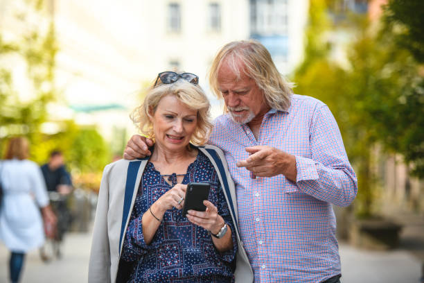 istock Senior Caucasian Couple Tourists Using A Smart Phone 1407315924