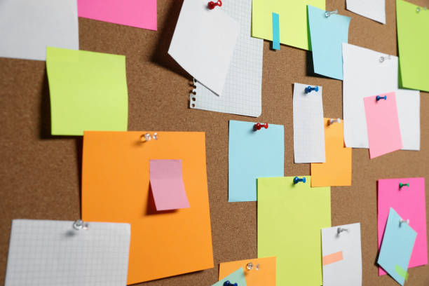 istock Many colorful notes pinned to cork board, closeup 1407316472