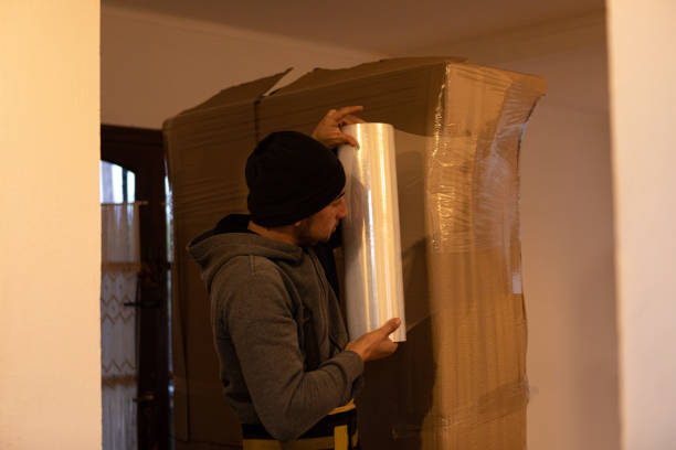 istock House moving process. Owner and moving staff packing, protecting and transporting furniture and movables to moving truck 1407316708