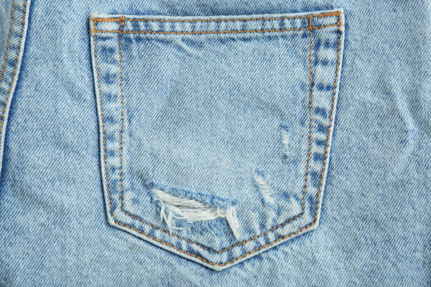 istock Stylish light blue jeans, closeup of back pocket 1407319681