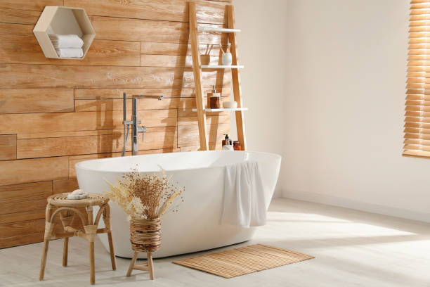 istock Bathroom interior with white tub and decor near wooden wall 1407320310
