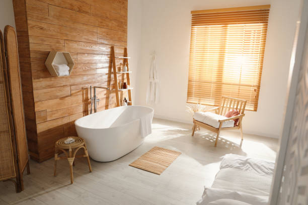 istock Stylish apartment interior with white bathtub and bed 1407320391