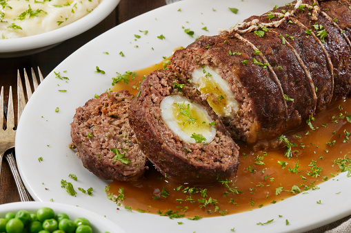 Hard Boiled Egg Stuffed Meatloaf with Creamy Mashed Potatoes, Green Peas and Gravy