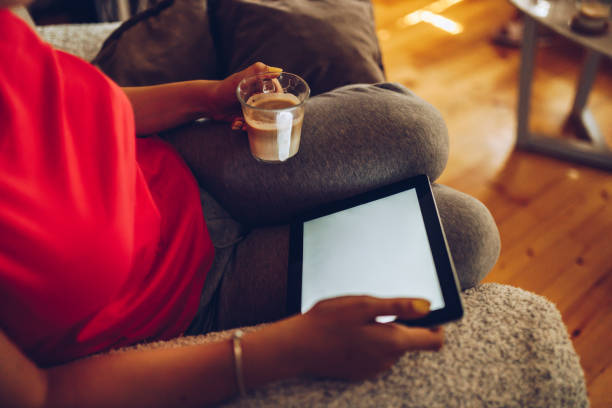 Young female  paying for a purchase using her smart phone and tablet