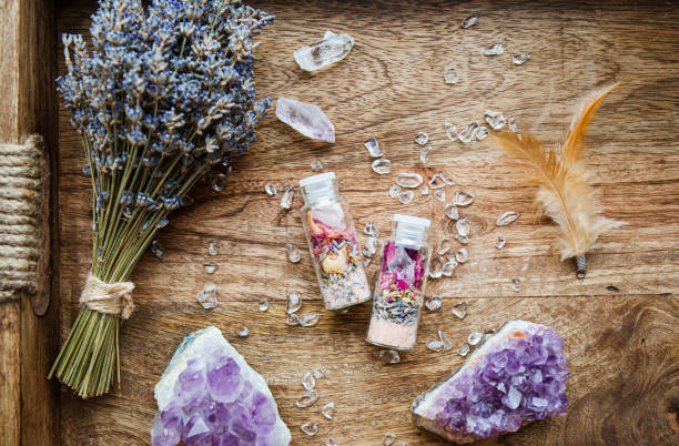 Homemade spell jar bottles with good intentions for home protection and inner balance. Filled with Himalayan rock salt, dried herbs flowers and semi precious stone chips. Magical item. stock photo