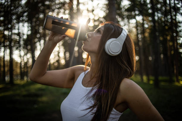 istock Young woman drinks water after training 1407327822