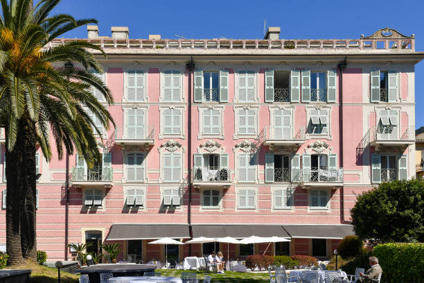 The façade in Art Nouveau style of a historic building transformed into a hotel with a Mediterranean garden, Rapallo, Genoa, Liguria, Italy Rapallo, Genoa, Liguria, Italy - 04 17 2022: Rapallo is a popular tourist destination on the Ligurian Sea coast, on the Tigullio Gulf, between Portofino and Chiavari, 25 kilometers from Genoa. historic building stock pictures, royalty-free photos & images