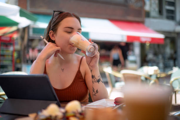 istock Young woman with digital tablet working while traveling 1407330131