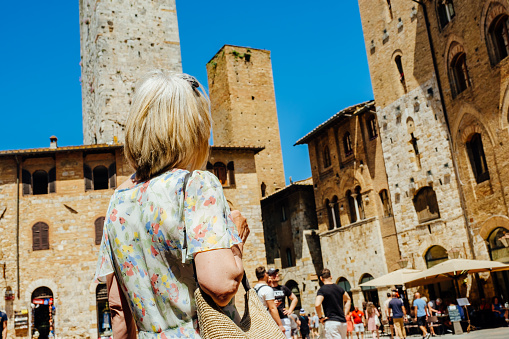 Woman at the town square in the village of San Gimignano, in the Tuscany region of Italy.
