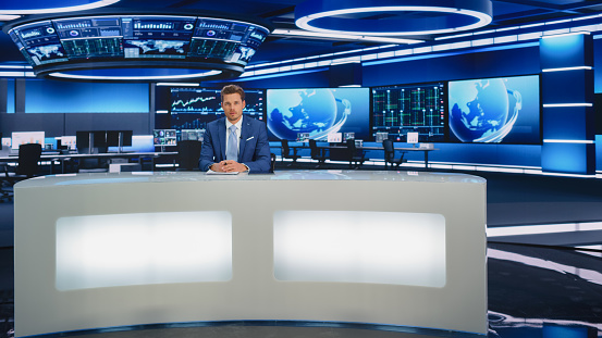 Beginning Evening News TV Program: Anchor Presenter Reporting on Business, Economy, Science, Politics. Television Cable Channel Anchorman Talks. Broadcast Network Newsroom Studio.