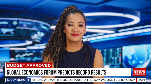 istock TV Live News Program: Female Presenter Reporting. Television Cable Channel Black Anchorwoman Talks. Mock-up Network Broadcasting Concept in Newsroom Studio. Medium Shot 1407333920
